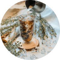 a glass of milk coffee with ice
